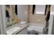 Bathroom featuring a granite countertop vanity, decorative gold candles, and an accessible walk-in tub at 12209 Putter Green Ct, New Port Richey, FL 34654