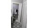 Bathroom with stylish black and white patterned floor tiles at 12209 Putter Green Ct, New Port Richey, FL 34654