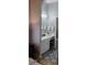 Stylish bathroom with a dual sink vanity, decorative mirrors, patterned floors, and modern lighting at 12209 Putter Green Ct, New Port Richey, FL 34654