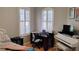 Bedroom or office space with large window, hardwood floors, a white piano, and a desk with a computer at 12209 Putter Green Ct, New Port Richey, FL 34654