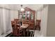 Elegant dining room with decorative chandelier, formal wooden furniture, and marble tile floor at 12209 Putter Green Ct, New Port Richey, FL 34654