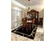 Traditional dining room boasting marble floors, a wooden dining set, and an ornate china cabinet under a chandelier at 12209 Putter Green Ct, New Port Richey, FL 34654