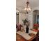 Dining area with a rustic chandelier and wooden dining table at 12209 Putter Green Ct, New Port Richey, FL 34654