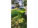 Charming home with a well-maintained lawn, mature trees, and a circular flower bed in a peaceful residential setting at 12209 Putter Green Ct, New Port Richey, FL 34654