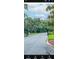 Gated community entrance offers privacy and security amidst a lush, green landscape at 12209 Putter Green Ct, New Port Richey, FL 34654