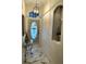 Inviting foyer with a glass table, decorative lighting, and a decorative display niche at 12209 Putter Green Ct, New Port Richey, FL 34654