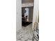 Inviting hallway leading to a dining area with marble-style flooring at 12209 Putter Green Ct, New Port Richey, FL 34654