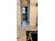 Hallway featuring marble floors leading to the bathroom with tub and shower at 12209 Putter Green Ct, New Port Richey, FL 34654