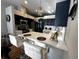 Modern kitchen with white countertops, bar seating and stainless appliances at 12209 Putter Green Ct, New Port Richey, FL 34654