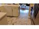Bright kitchen with stainless appliances, white cabinets, and marble tile floor at 12209 Putter Green Ct, New Port Richey, FL 34654