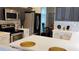 Modern kitchen with stainless steel appliances, stylish backsplash, and island with white countertop at 12209 Putter Green Ct, New Port Richey, FL 34654