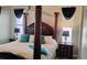 Elegant main bedroom features a four-poster bed, side tables with lamps, and stylish curtains at 12209 Putter Green Ct, New Port Richey, FL 34654