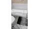 Featuring an accessible bathtub with a convenient door, complemented by a textured bathmat at 12209 Putter Green Ct, New Port Richey, FL 34654