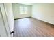 An empty bedroom with hardwood floors and a window is ready for decor at 2607 Seagull Ln, North Port, FL 34286