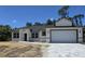 New construction shows a charming one-story home with a two-car garage and paver driveway at 2607 Seagull Ln, North Port, FL 34286