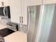 Modern kitchen featuring stainless steel appliances, tile backsplash, and white cabinets at 2607 Seagull Ln, North Port, FL 34286
