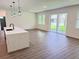 Open floor plan featuring a kitchen with island flowing into the living room with sliding doors to the outdoors at 2607 Seagull Ln, North Port, FL 34286