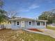 Charming single-story home featuring a white front door and a light blue exterior at 5606 N 32Nd St, Tampa, FL 33610