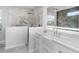 This bathroom features a sleek shower, a large vanity, and an illuminated mirror at 6741 64Th E Ter, Bradenton, FL 34203