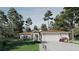Charming one-story home with a three-car garage, well-manicured lawn, and lush landscaping at 8301 Burwell Cir, Port Charlotte, FL 33981