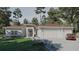 Inviting one-story home with manicured lawn, featuring a covered entryway and attached three-car garage at 8301 Burwell Cir, Port Charlotte, FL 33981