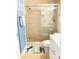 Cozy bathroom featuring a glass shower and a fun fish-shaped rug at 19417 Gulf Blvd # B209, Indian Rocks Beach, FL 33785