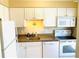 Kitchen with white cabinets, granite countertops, and stainless steel appliances at 19417 Gulf Blvd # B209, Indian Rocks Beach, FL 33785