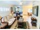 Living room with a sofa and chairs, tile floor and tropical-themed decor at 19417 Gulf Blvd # B209, Indian Rocks Beach, FL 33785
