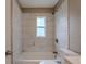 This renovated bathroom features bright tile and a shower at 3408 Phillips St, Tampa, FL 33619