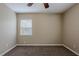 Cozy bedroom with neutral paint, carpet, ceiling fan and a window at 3408 Phillips St, Tampa, FL 33619