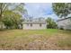 Back exterior view of a quaint, single-story home with a well-maintained lawn at 3408 Phillips St, Tampa, FL 33619