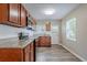 Well-lit kitchen features wood cabinets, granite countertops, stainless steel appliances, and wood flooring at 3408 Phillips St, Tampa, FL 33619