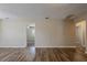 Spacious living area with wood floors, neutral paint, and an open doorway at 3408 Phillips St, Tampa, FL 33619