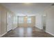 Bright living room with wood floors, two windows with blinds, and a ceiling fan at 3408 Phillips St, Tampa, FL 33619
