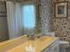 Bathroom featuring a vanity, mirror, floral wallpaper and a shower tub at 4620 Blue Marlin Dr, Bradenton, FL 34208