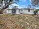 Exterior view of home with a screened in porch and spacious backyard at 5321 Baroque Dr, Holiday, FL 34690