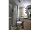 Bright bathroom features a shower, toilet, vanity, and light fixtures at 22621 Saint Thomas Cir, Lutz, FL 33549