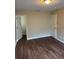 Bedroom with neutral paint, dark floors, and a closet at 10509 Marsanne Pl, Riverview, FL 33578