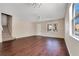 Bright living room with wood floors, ceiling fan, and staircase access at 10509 Marsanne Pl, Riverview, FL 33578