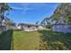 Backyard with an outdoor seating area, large grassy area, and an outdoor shower at 12339 138Th N St, Largo, FL 33774