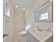 Bathroom featuring tile walls, updated vanity, large mirror, and a tiled shower at 12339 138Th N St, Largo, FL 33774
