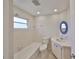 Bathroom with shower/tub combo, white tile walls, and updated vanity with a blue framed mirror at 12339 138Th N St, Largo, FL 33774