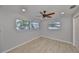 Bedroom features light, neutral walls, ceiling fan, wood-look floors, and plenty of natural light at 12339 138Th N St, Largo, FL 33774