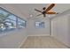 Bedroom features natural light, wood-look floors, ceiling fan, and sliding closet door at 12339 138Th N St, Largo, FL 33774