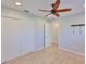 Bedroom features wood-look flooring, ceiling fan, neutral walls and closet with sliding doors at 12339 138Th N St, Largo, FL 33774