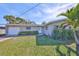 Inviting single story home with a well-maintained lawn, mature plants, and an attached garage at 12339 138Th N St, Largo, FL 33774