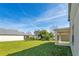 Expansive backyard with lush green grass, mature landscaping, and a covered patio, perfect for outdoor relaxation and entertaining at 15107 Searobbin Dr, Lakewood Ranch, FL 34202