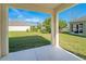 A covered patio with a view of the backyard, landscaping, and water feature at 15107 Searobbin Dr, Lakewood Ranch, FL 34202