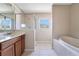 Bathroom featuring a shower and a garden tub at 15107 Searobbin Dr, Lakewood Ranch, FL 34202