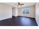 Bedroom featuring a ceiling fan, dark vinyl floors, and a window providing ample natural light at 15107 Searobbin Dr, Lakewood Ranch, FL 34202